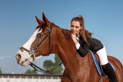 Close-up of horse standing against clear sky