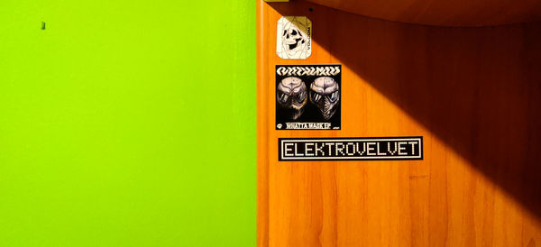 Close-up of information sign on wall