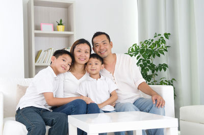 Happy family sitting on sofa at home