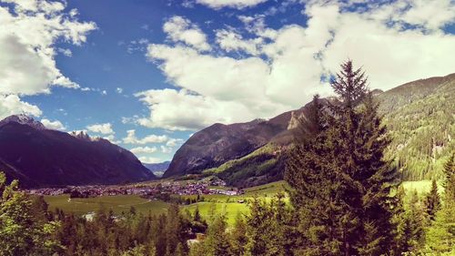 Scenic view of mountains against cloudy sky