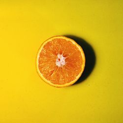 Close-up of apple against orange background