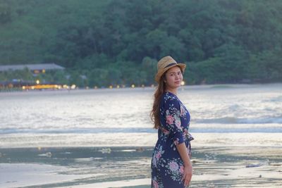 Young woman standing at beach