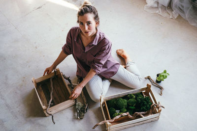 Portrait of smiling young woman sitting in basket