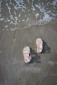 High angle view of abandoned shoes on sand