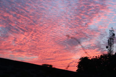 Low angle view of silhouette trees against sky at sunset