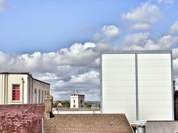 Low angle view of building against cloudy sky