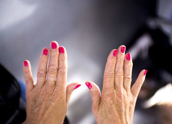 Close-up of cropped hands with nail polish