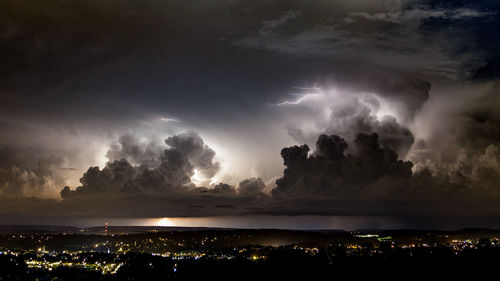 Panoramic view of illuminated city against sky at night