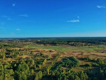 Scenic view of landscape against blue sky