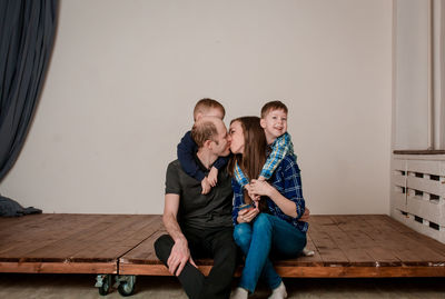 Mom and dad kiss in front of the children. young parents