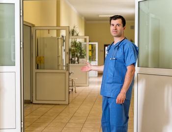 Man standing in corridor of building