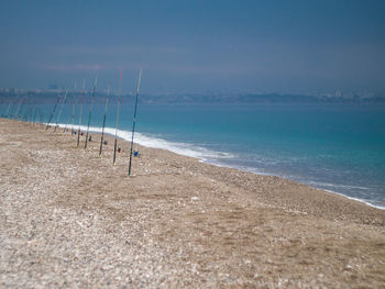 Fishing rods in row at beach