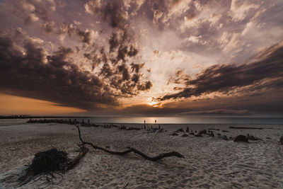 Scenic view of beach against sky during sunset