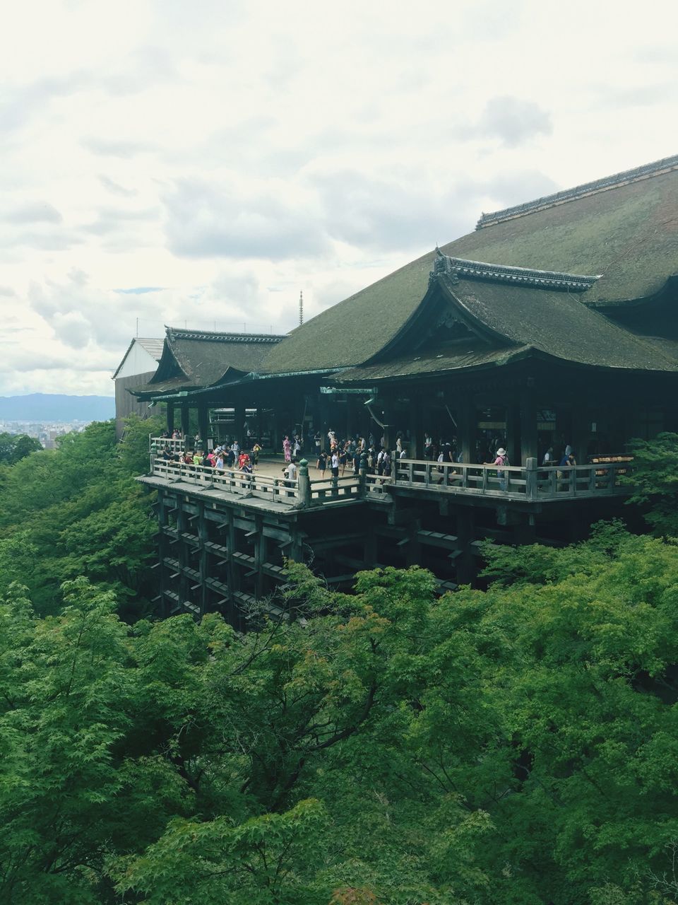 architecture, built structure, sky, building exterior, tree, cloud - sky, transportation, cloudy, mode of transport, green color, house, day, cloud, growth, nature, mountain, travel, outdoors, bridge - man made structure, nautical vessel