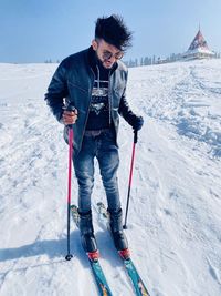 Full length of man standing on snow covered landscape