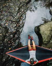 High angle view of woman lying on rock