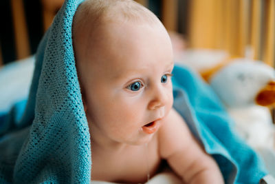 Close-up of cute baby boy in crib