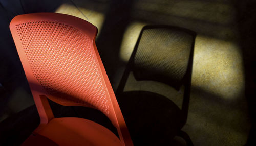 Close-up of chairs in illuminated room