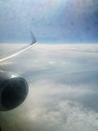 Aerial view of airplane flying in sky