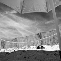 View of tent on mountain against cloudy sky