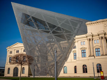 Low angle view of buildings against blue sky