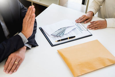 Midsection of man using mobile phone