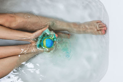 High angle view of woman hand in water