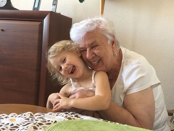 Portrait of smiling grandmother and daughter playing