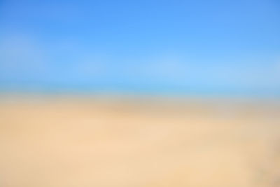 Defocused image of landscape against clear blue sky