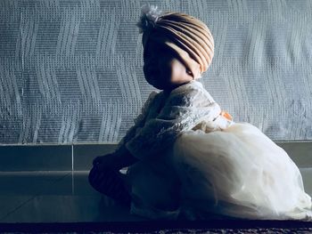 Boy sitting in curtain