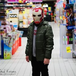 Full length of man wearing mask standing in store