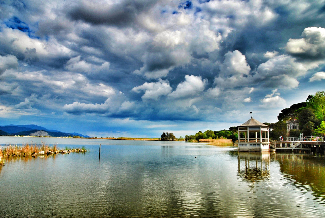 water, sky, cloud - sky, built structure, architecture, waterfront, building exterior, cloudy, cloud, lake, tranquil scene, tranquility, scenics, reflection, beauty in nature, nature, tree, house, overcast, idyllic