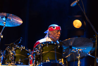 Man performing in music concert at night