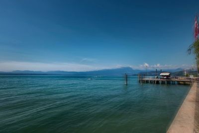 Scenic view of sea against clear blue sky