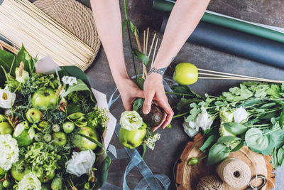 High angle view of woman holding fruits