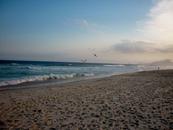 Scenic view of beach against sky during sunset