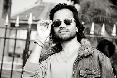 Portrait of young man smoking cigarette outdoors