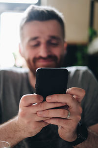 Midsection of man using mobile phone