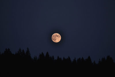 Low angle view of moon against sky at night