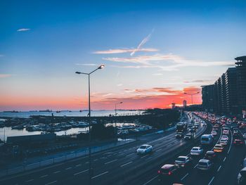 Traffic on road at sunset