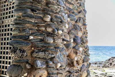 Close-up of rocks on beach against clear sky