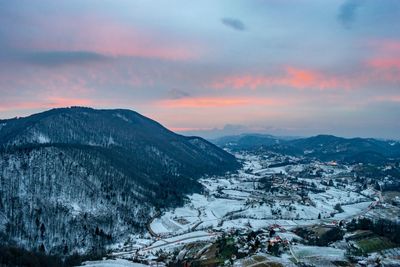 Scenic view of snowcapped mountains against sky during sunset