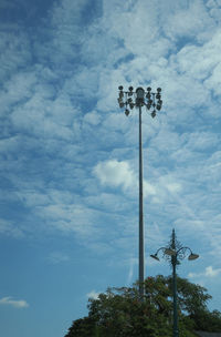 Low angle view of floodlight against cloudy sky
