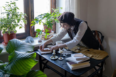 Young woman using mobile phone while sitting at home