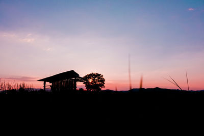 Silhouette built structures against sky during sunset