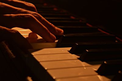 Close-up of man playing piano