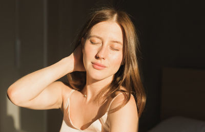 Portrait of young woman sitting at home