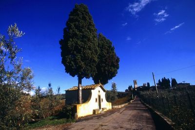 Road leading towards blue sky