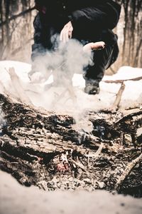 Reflection of man and woman on log in forest
