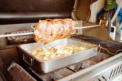Close-up of meat on barbecue grill in kitchen